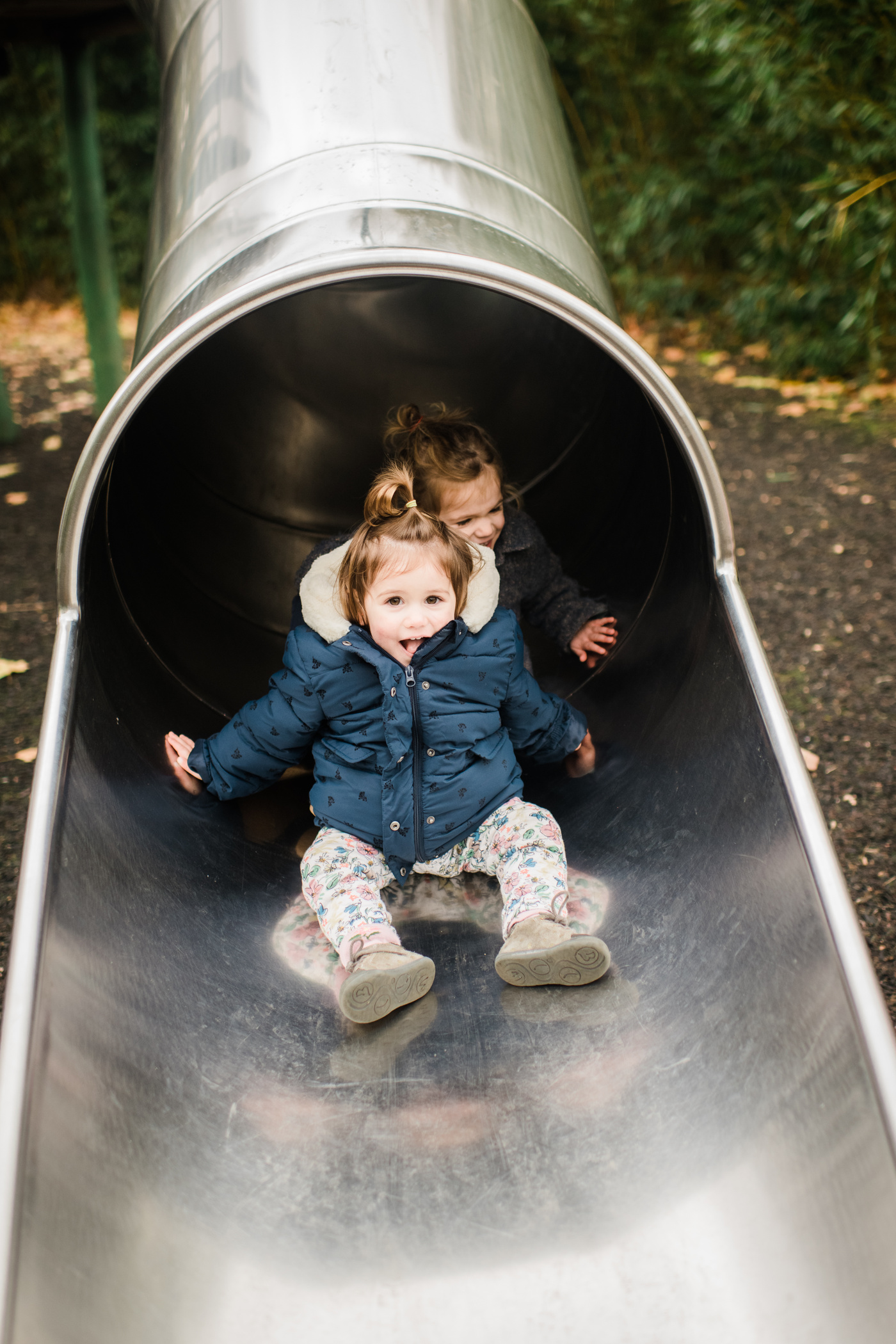 Toddlers enjoying a slide