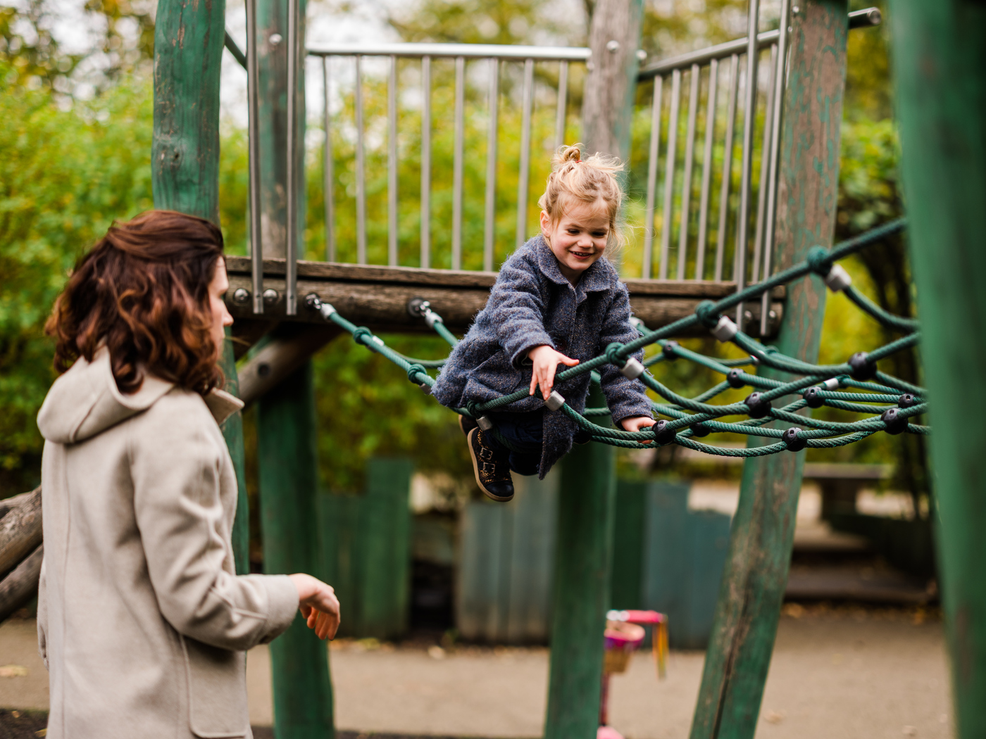 Young girl on a playground rope bridge