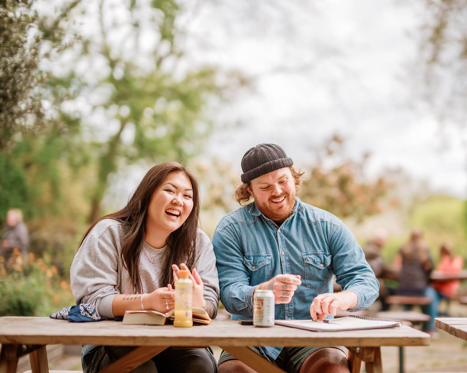 A man and woman at a picnic bench