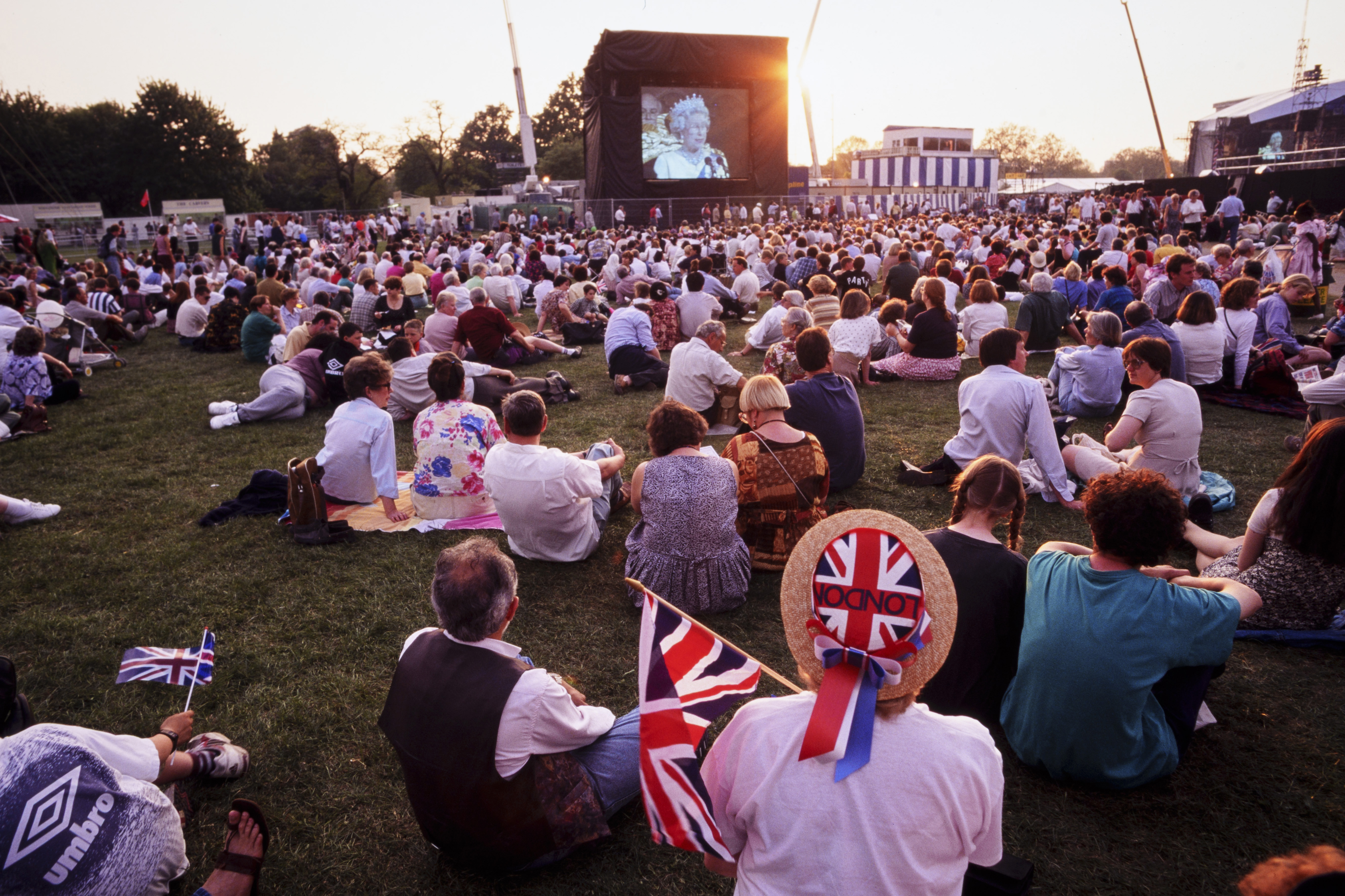 Crowds watch a broadcast by the late Queen Elizabeth II during the celebrations for the 50th anniversary of VE Day in 1995 