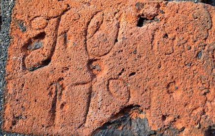 Letters scratched into the red brick of the Conduit House