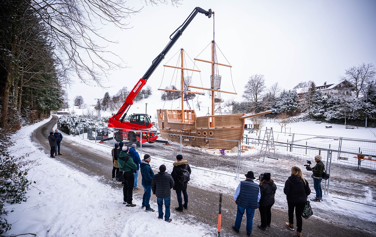 A crane lowers the crows nest in place on the new play galleon