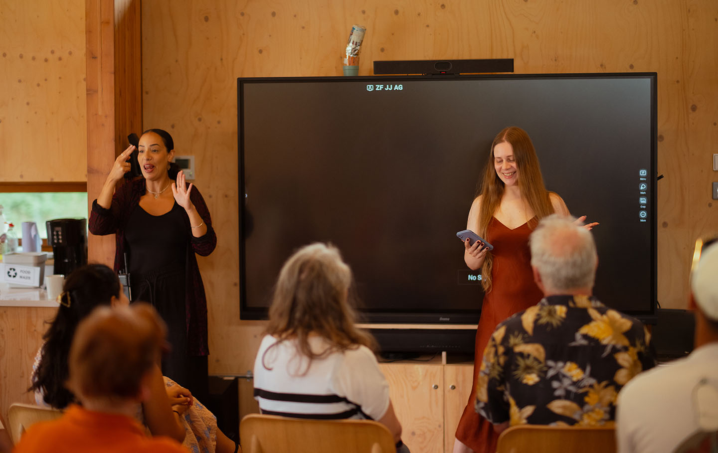 Artist Leah Clements presents 'The Very Alive Part' to an audience, with BSL Interpreter Sumayya Si-Tayeb