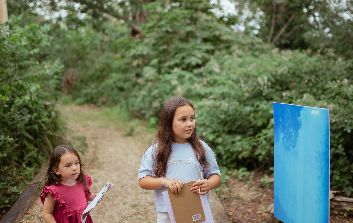 Two young girls looking at a pinhole camera photo