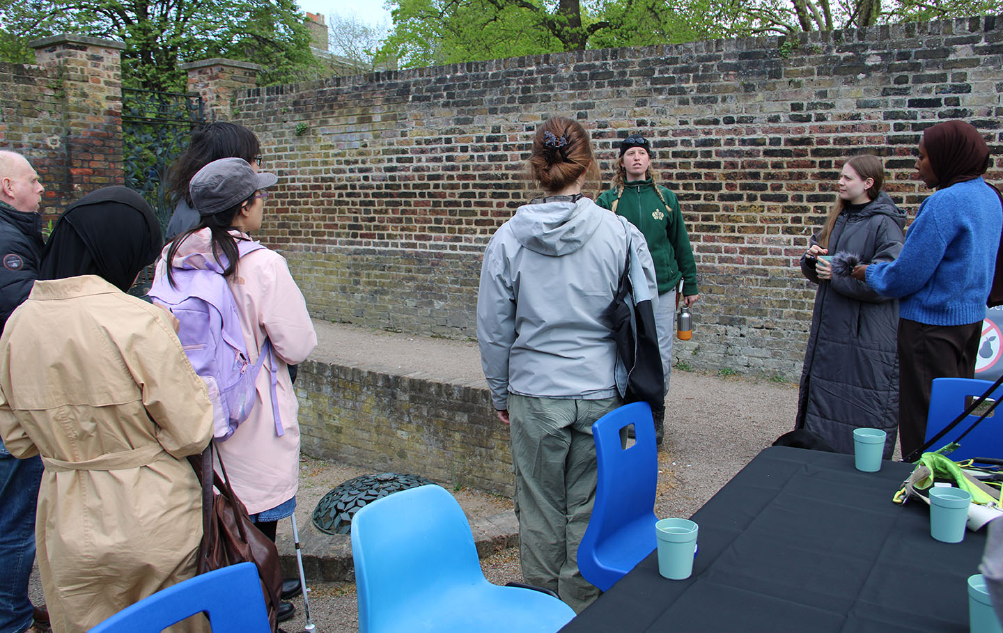 Artist Leah Clements talking to a group in the Queen's Orchard