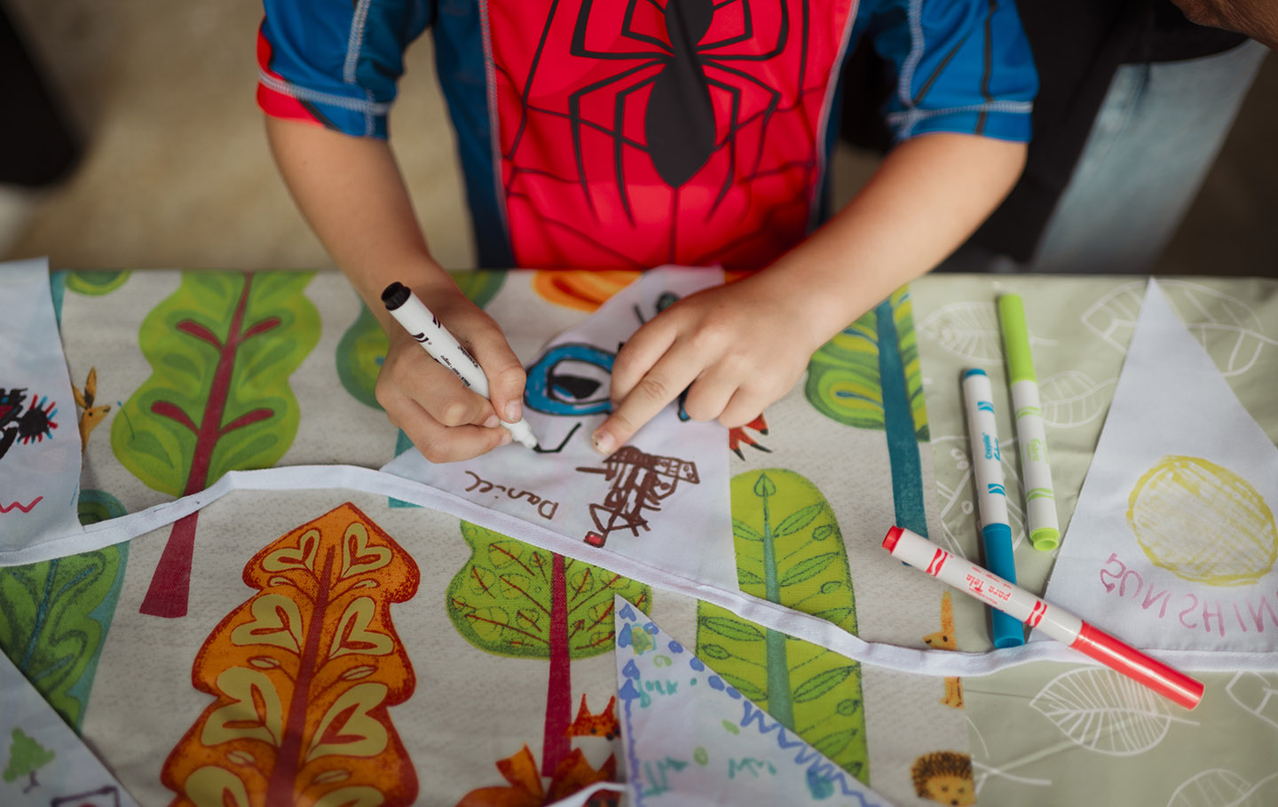 Young child decorating bunting