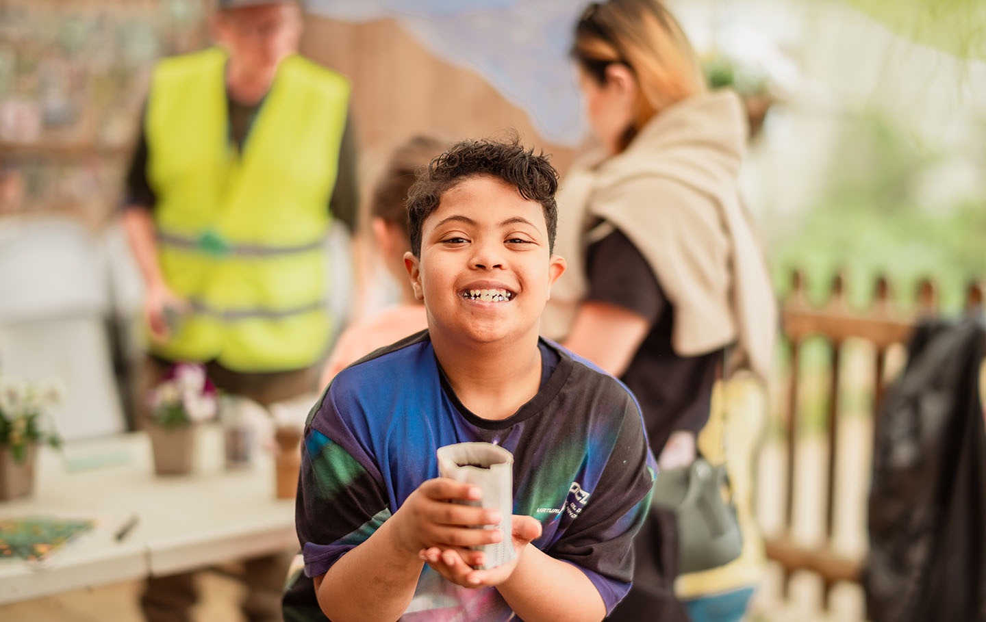 Young boy with a newspaper plant pot