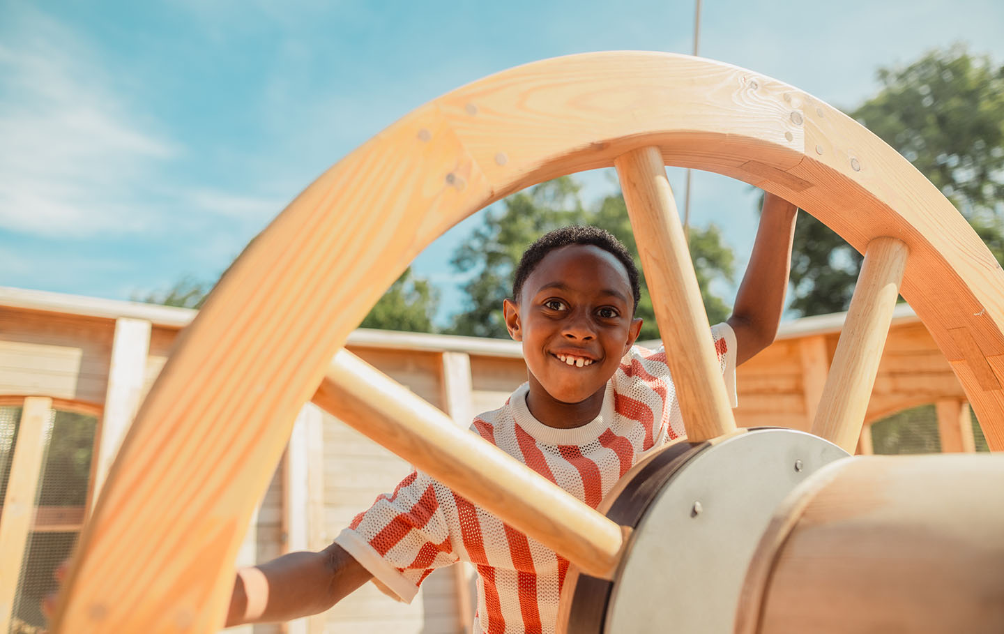 Young boy at the ship's wheel