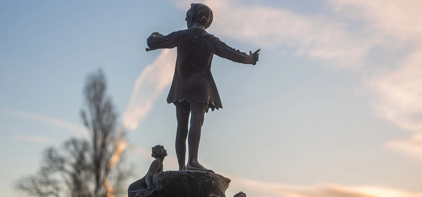 Peter Pan statue against the morning sky