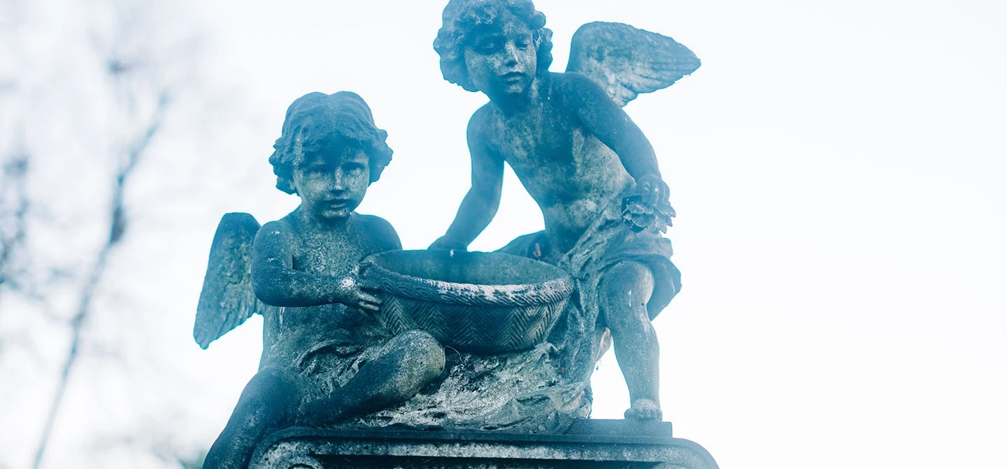 Carved angels on top of a memorial stone