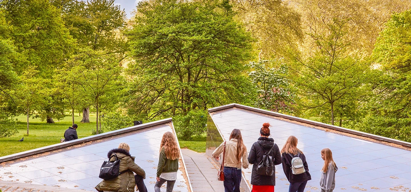 People looking at the Canada memorial in springtime