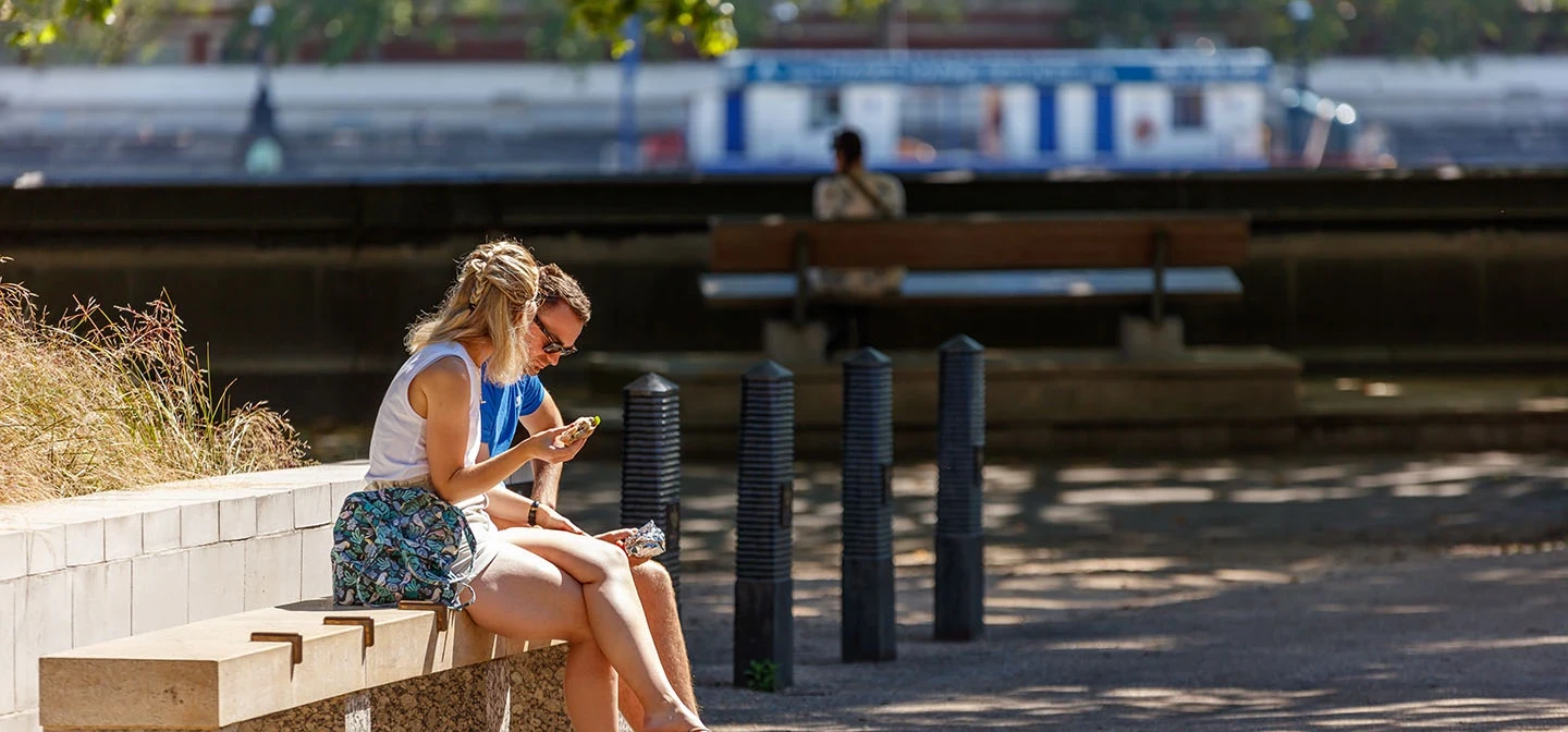 Two people sitting on a bench