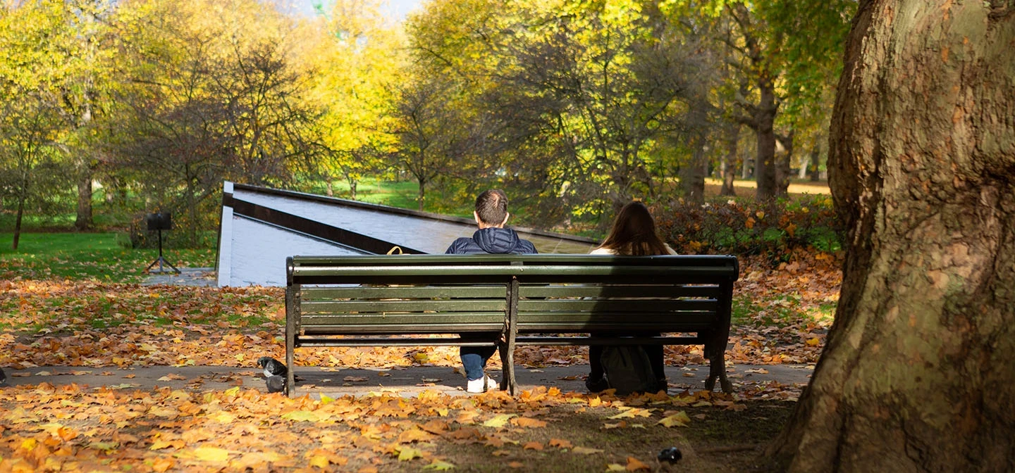 Couple sitting on a bench by the Canada Memorial