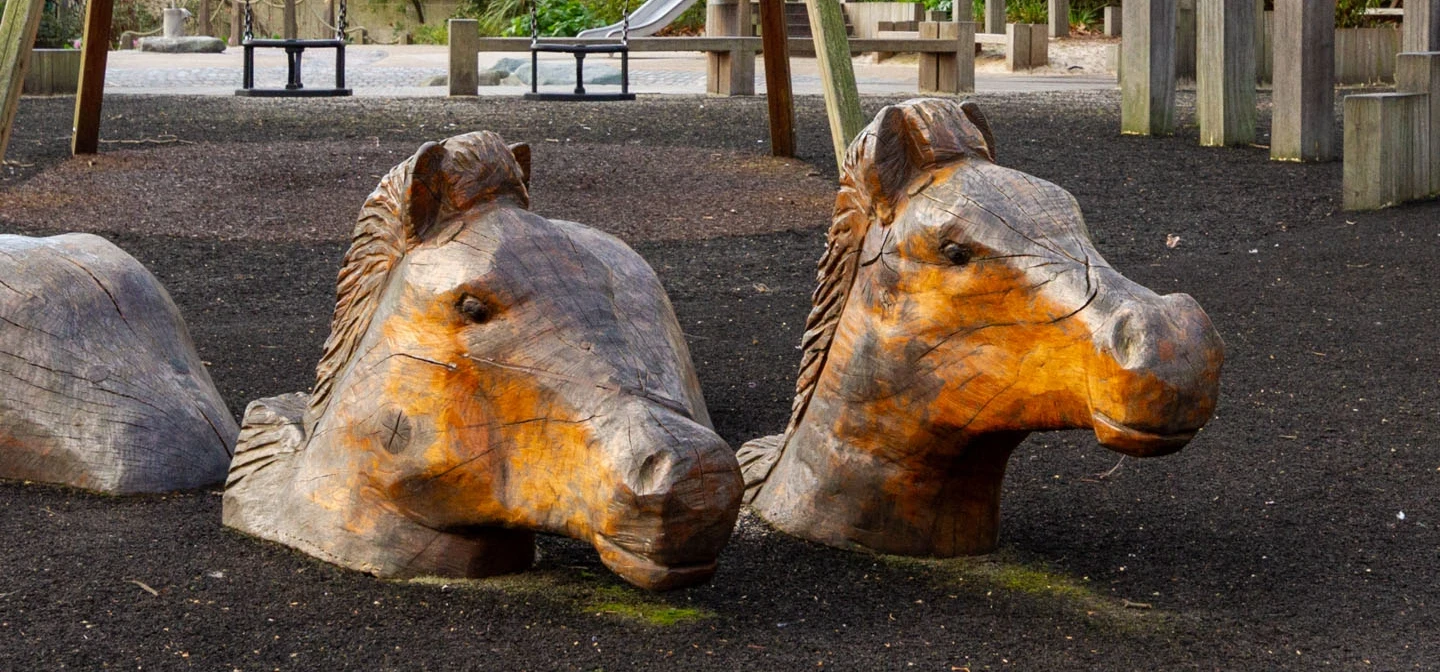 Carved wooden horse heads in Horseferry Playground