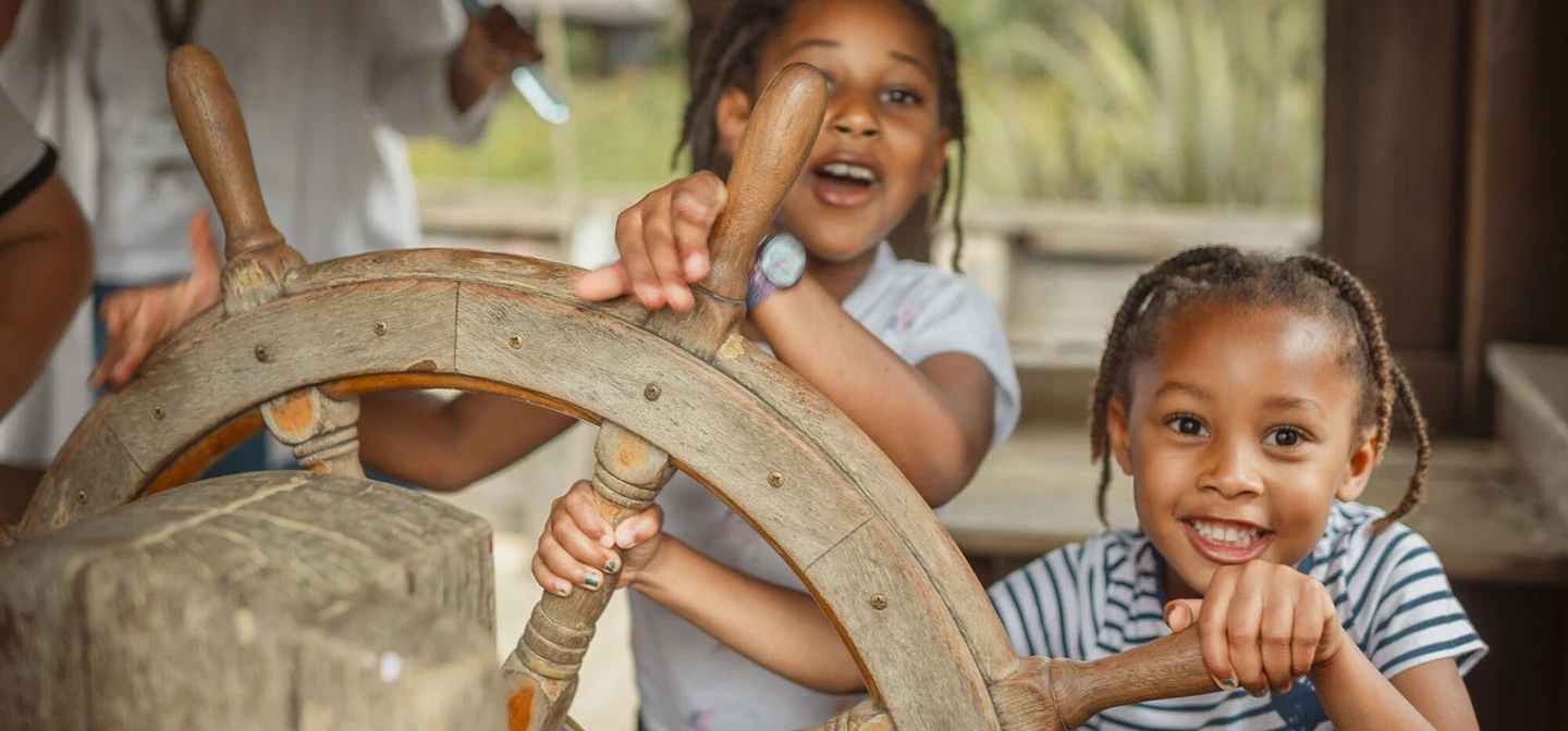 Two children at the ship's wheel