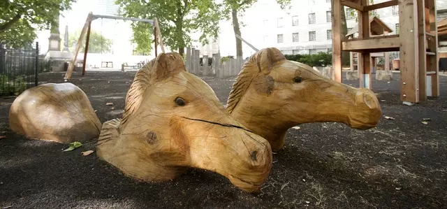 Wooden carved horse heads at Horseferry playground