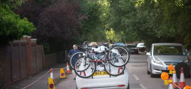 The back of a car driving through Richmond Park, bicycles are on the back of the vehicle