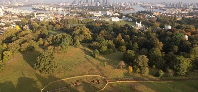 An aerial view of Greenwich Park and the Saxon Barrow Cemeteries with Canary Wharf in the distance