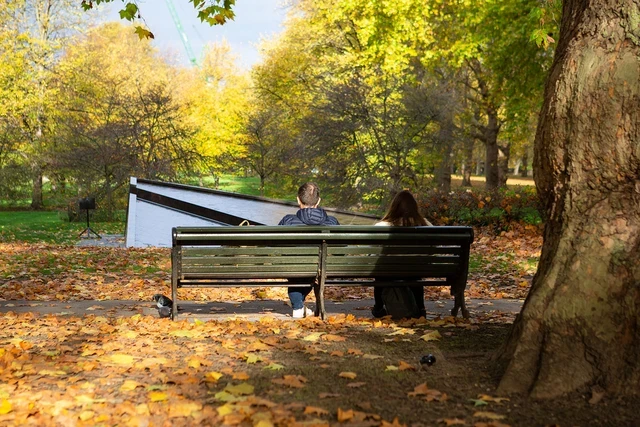 Couple sitting on a bench by the Canada Memorial