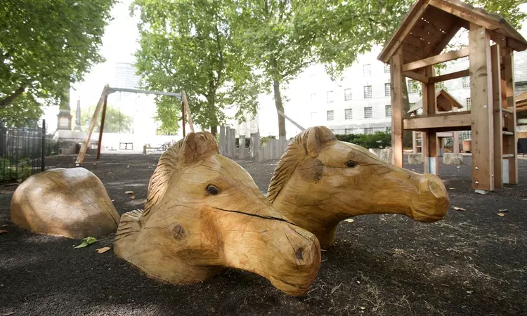 Wooden carved horse heads at Horseferry playground