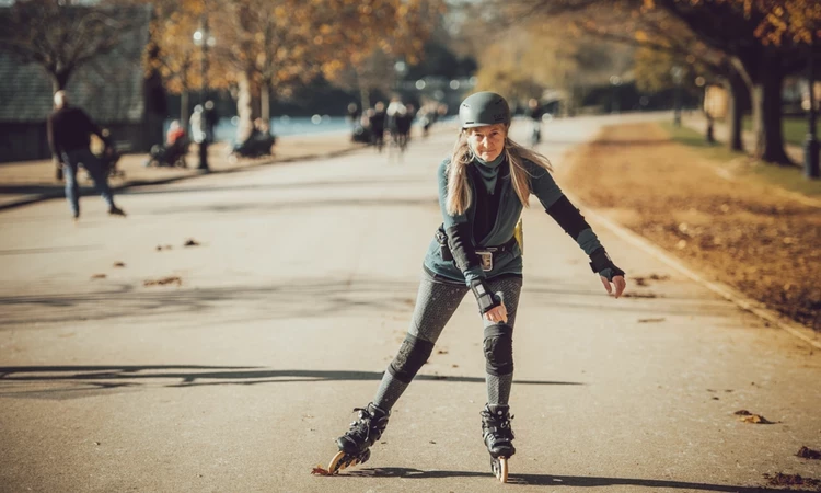 Woman skating next to the Serpentine lake in Hyde Park