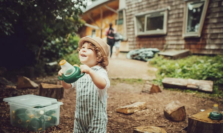 A young child looking for bugs