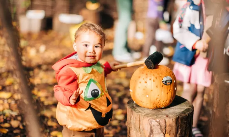 A child wearing a pumpkin Halloween costume