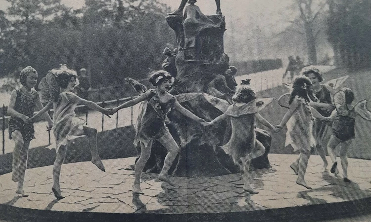 Children dancing around the Peter Pan statue, 1935