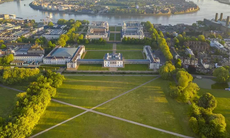 An aerial view of Greenwich Park and the Queen's House looking toward the River Thames and Canary Wharf