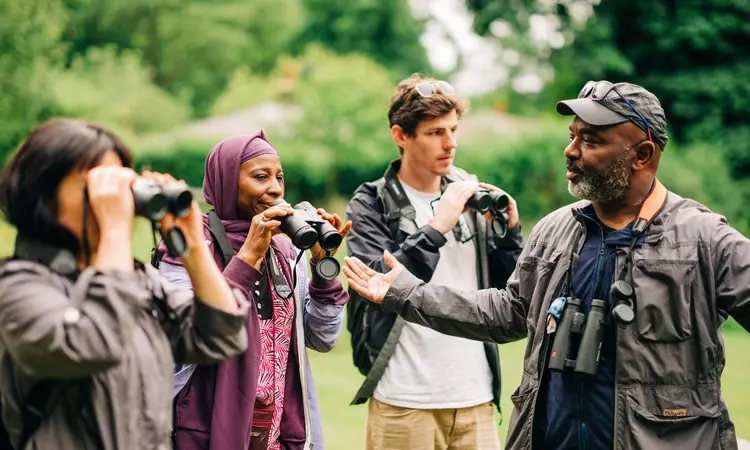 A group od people on a bird watching tour with David Lindo, the Urban Birder.