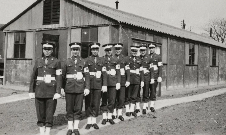 Officers standing in a row outside a building in Camp Griffiss