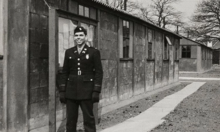 Officer standing outside a brick building in Camp Griffiss