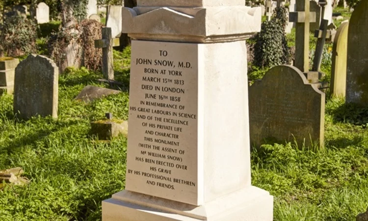 John Snow Grave - White memorial topped with draped urn