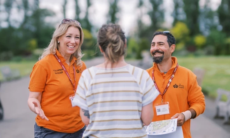Volunteer Rangers chatting to a park visitor