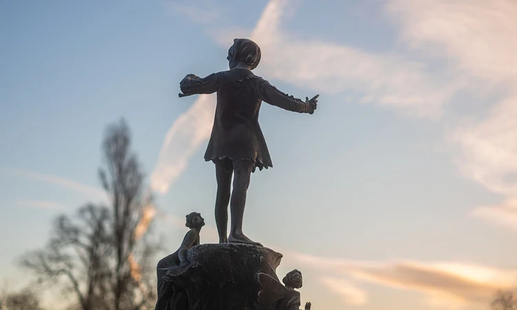 Peter Pan statue against the morning sky