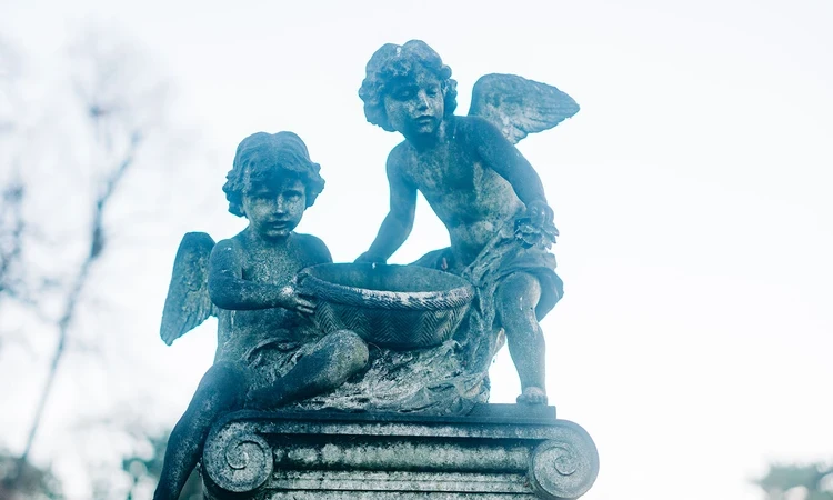 Carved angels on top of a memorial stone