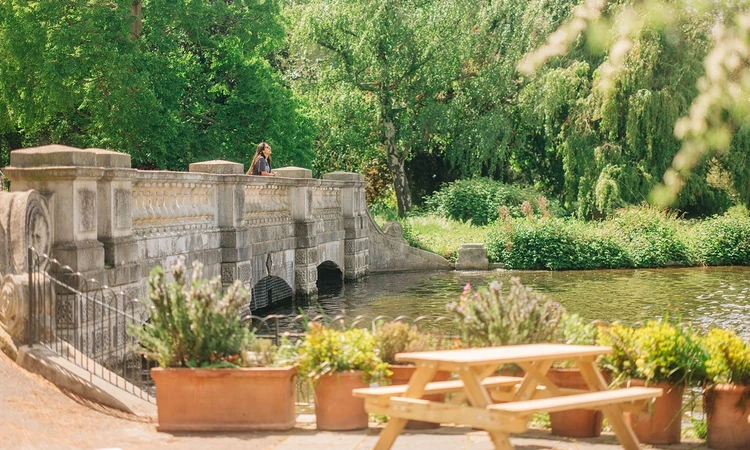 The Dell bridge viewed from outdoor seating at Serpentine Bar & Kitchen