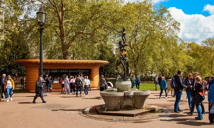 A busy food kiosk and decorative fountain in spring