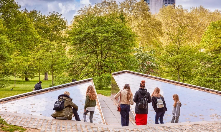 People looking at the Canada memorial in springtime