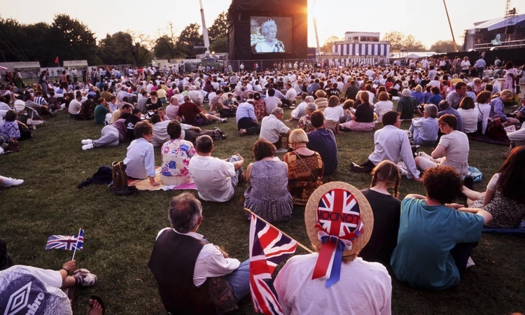 Crowds watch a broadcast by the late Queen Elizabeth II during the celebrations for the 50th anniversary of VE Day in 1995 