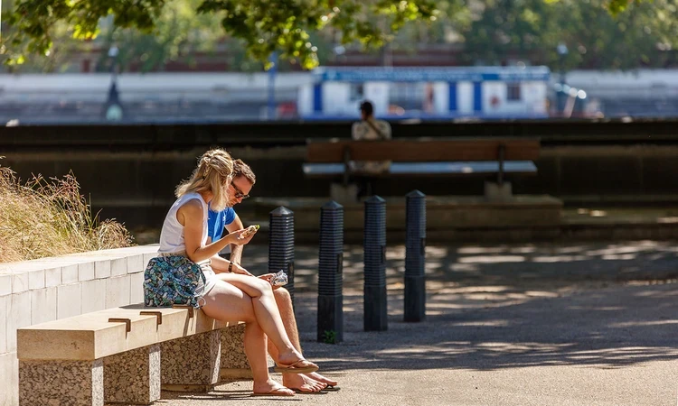 Two people sitting on a bench