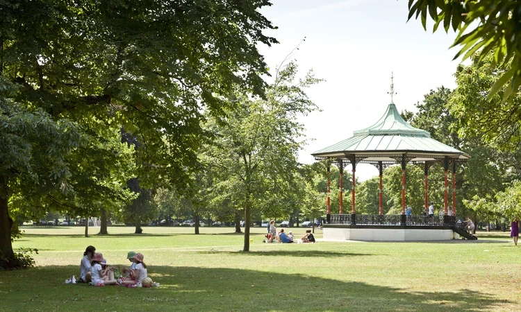 Image of a bandstand in a green, outdoor park. 