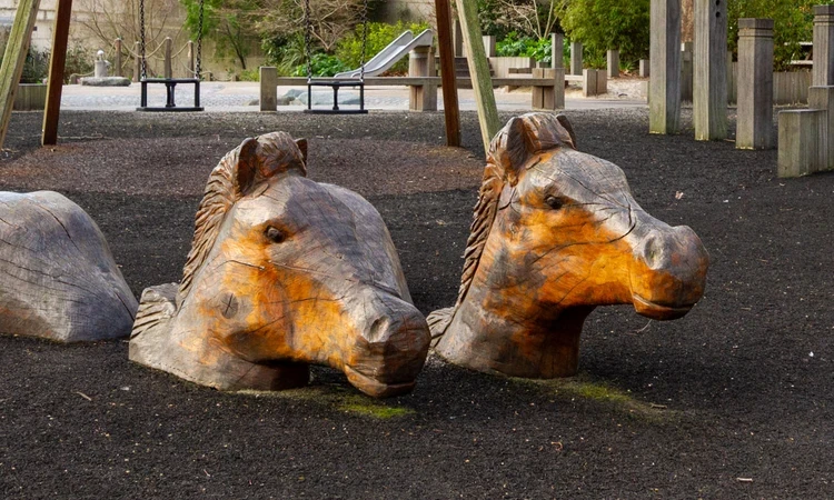 Carved wooden horse heads in Horseferry Playground