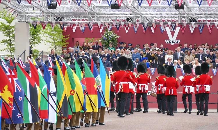 Soldiers with flags of the Commonwealth salute King Charles III