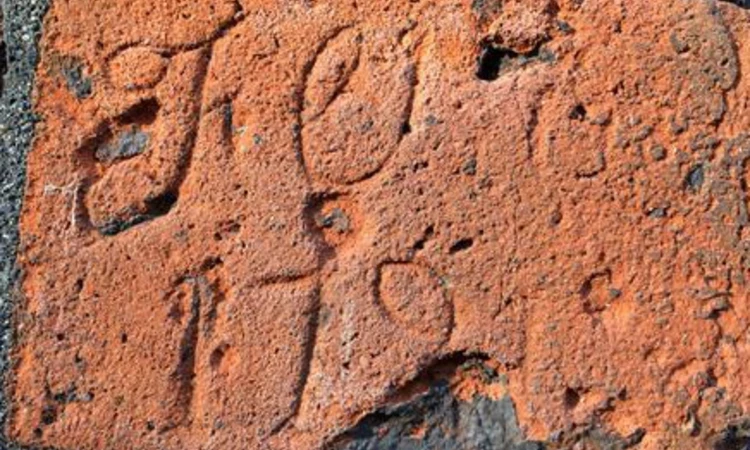 Letters scratched into the red brick of the Conduit House