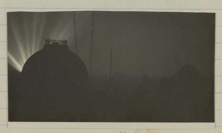 Black and white photograph showing Second World War searchlights over Greenwich Park