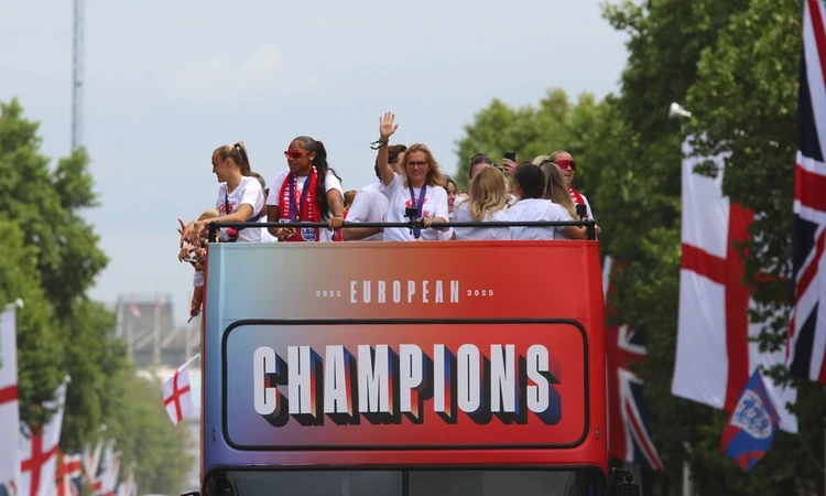 The 'Lionesses' wave to crowds and celebrate on an open-top bus