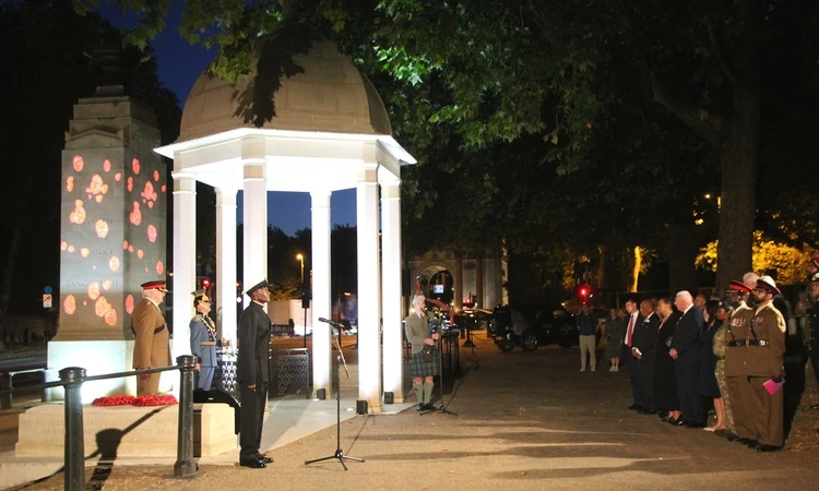 VJ Day 80 ceremony at the Memorial Gates at dusk.