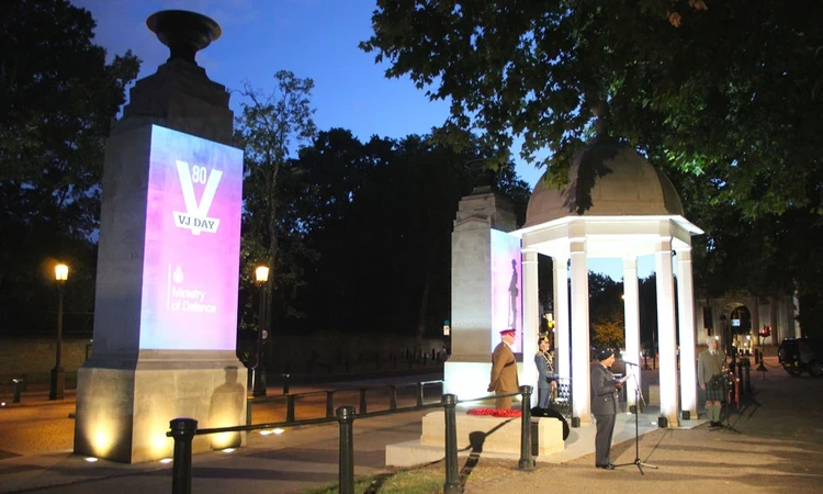 VJ Day 80 ceremony at the Memorial Gates at dusk.