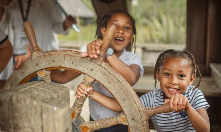 Two children at the ship's wheel